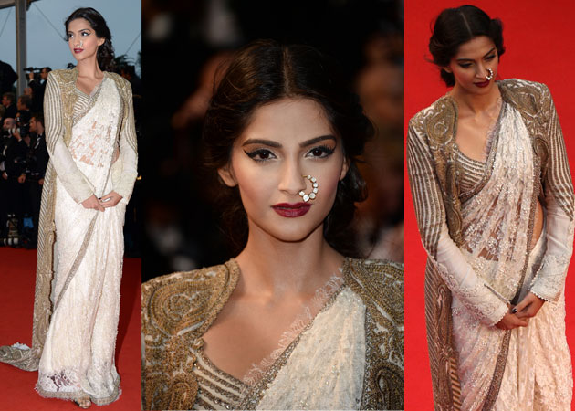 Sonam Kapoor in a white and gold designer saree (a long cape and striking nose-ring) – in 2013