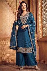 Model wearing traditional rama blue art silk embroidered palazzo suit