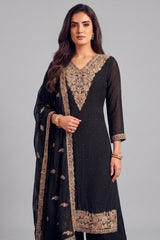 Close up of heavy antique silver embroidery on deep V neckline of black palazzo suit