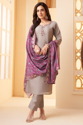 Model wearing traditional light grey art silk straight cut suit with printed dupatta