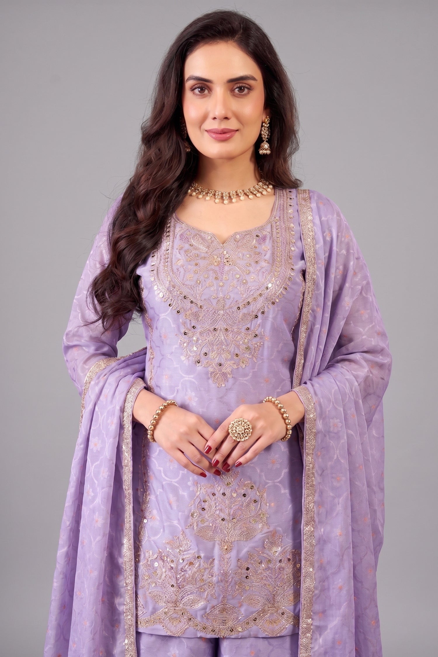 Close up of floral embroidery and applique work on lilac purple chinon silk suit