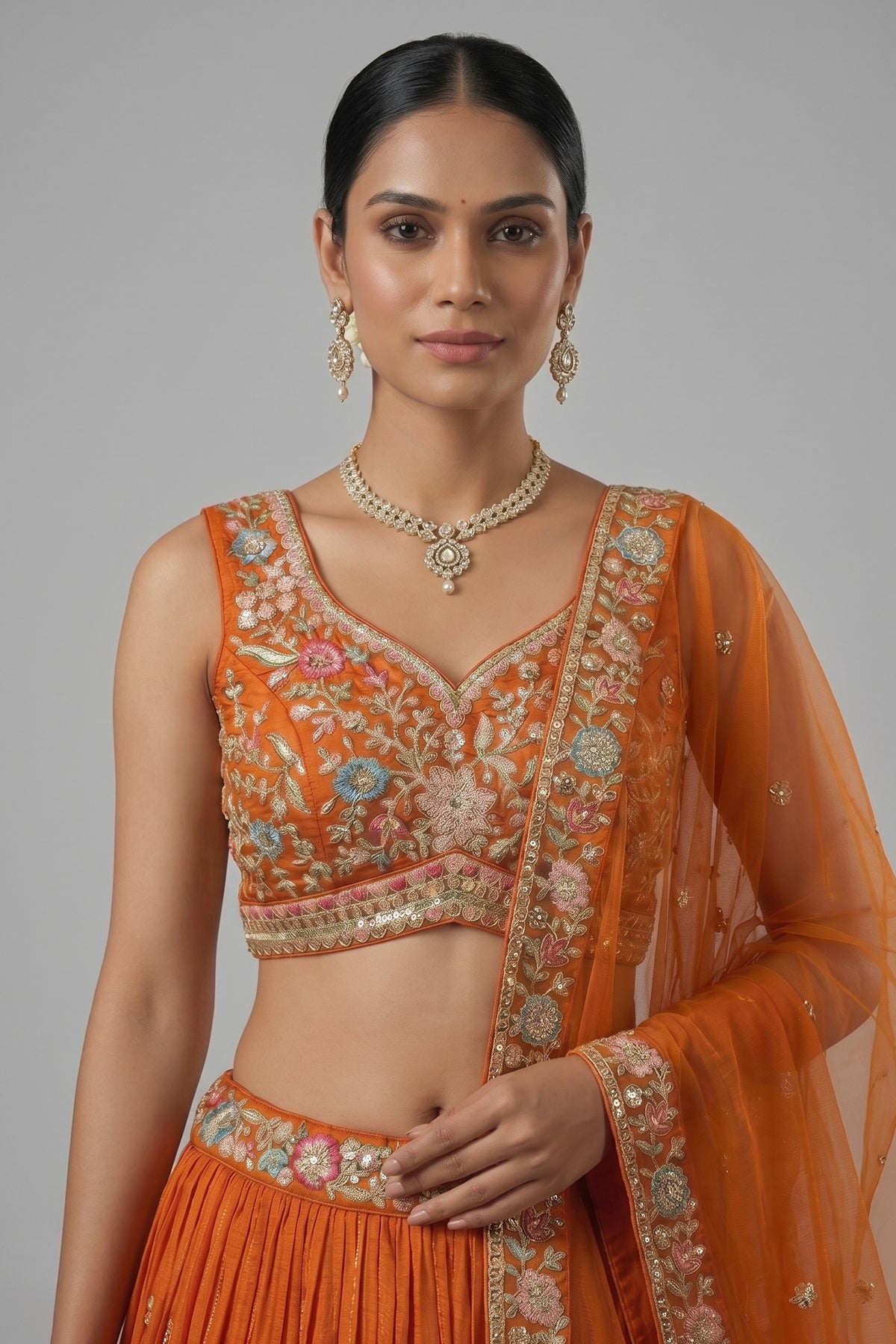 Orange Pleated Georgette Lehenga Choli with Embroidered Hem