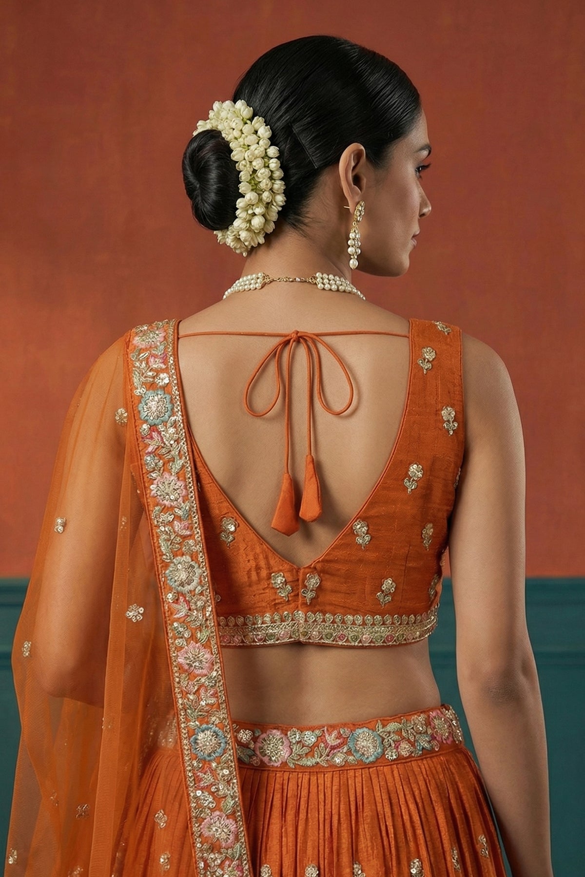 Orange Pleated Georgette Lehenga Choli with Embroidered Hem