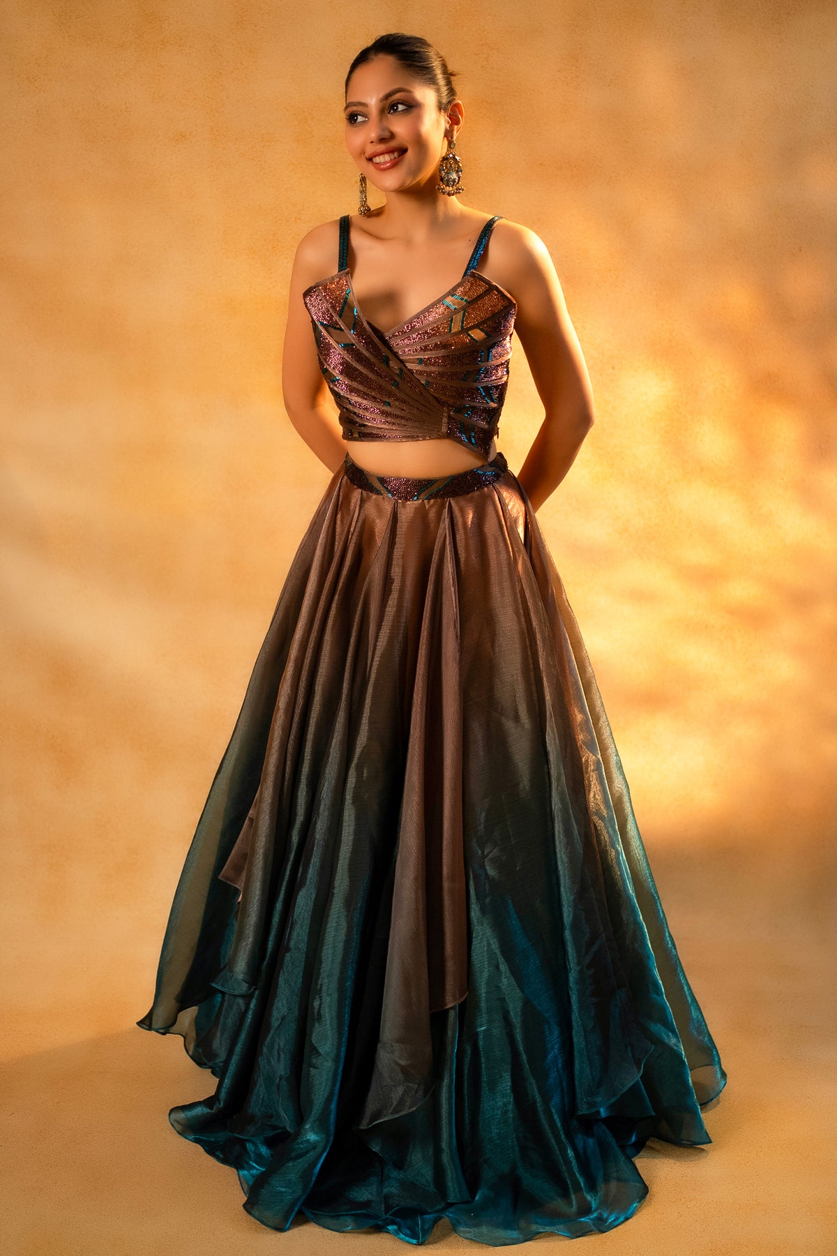Brown and Prussian Blue Glass Organza Asymmetrical Lehenga showcasing the voluminous layered skirt