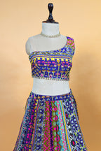 Blue Crepe Silk Printed Asymmetric Neckline Lehenga Set paired with a sheer net dupatta