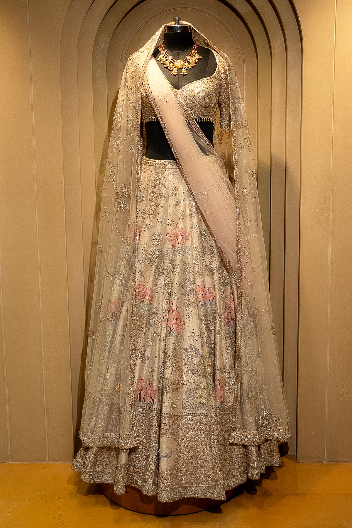 Close-up of the tropical flora motif on the Off White Silk Flamingo Lehenga