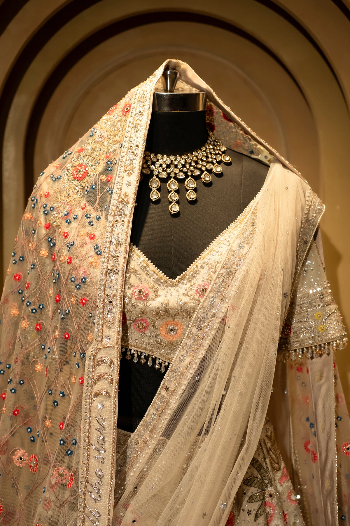 Ivory White Organza Lehenga with intricate embroidery and double dupatta display on a mannequin.