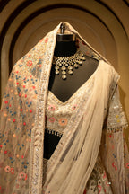 Ivory White Organza Lehenga with intricate embroidery and double dupatta display on a mannequin.