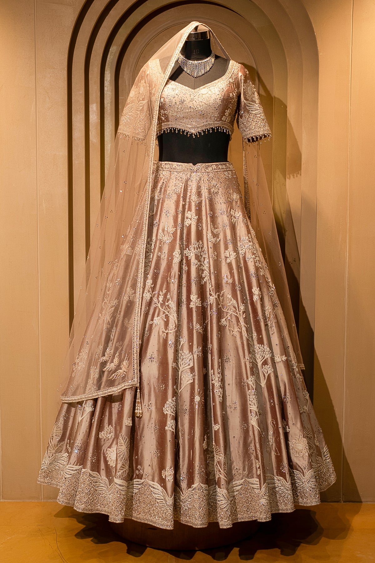 Close-up of the architectural border on the Champagne Brown Silk Lehenga