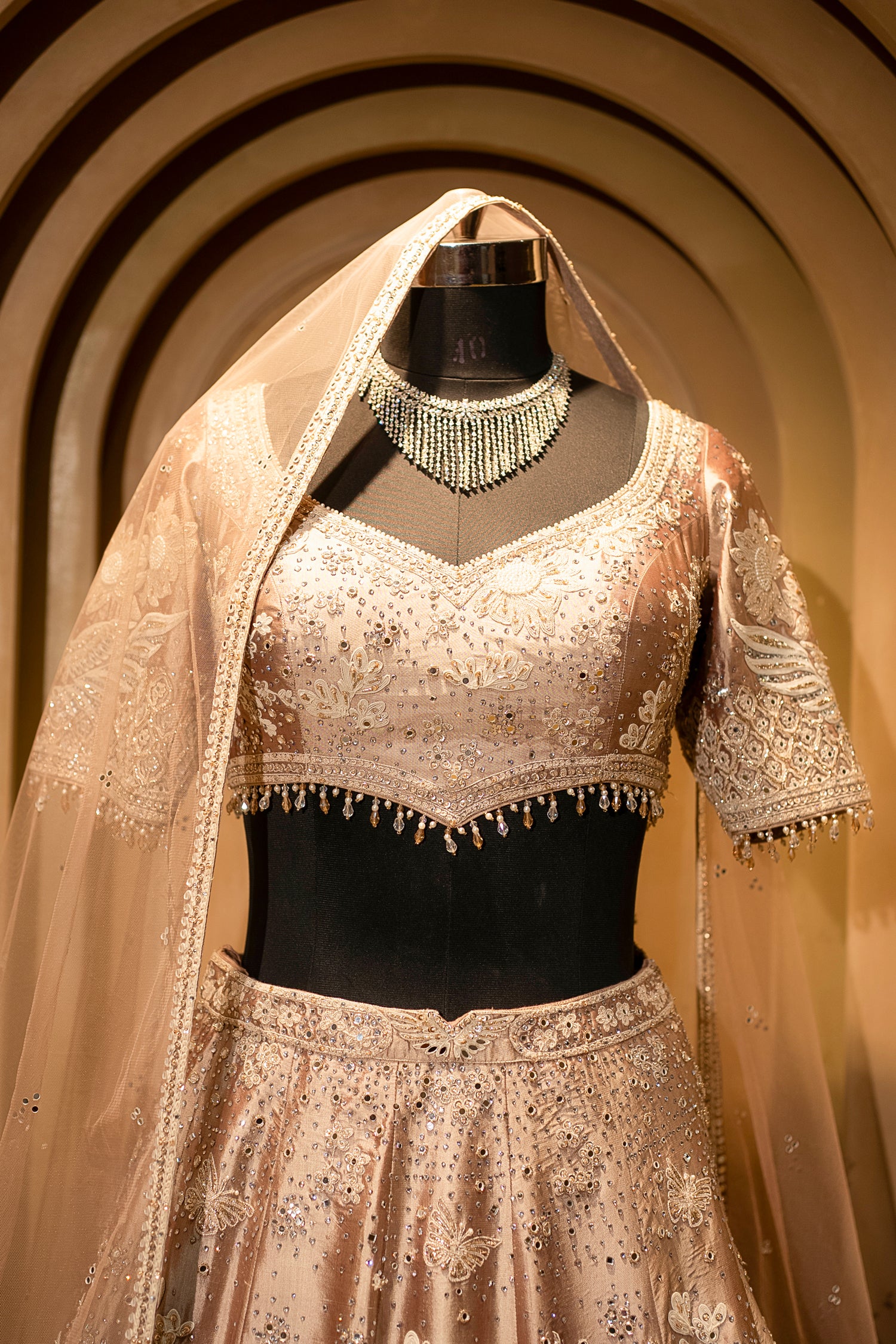 Intricate dori-mirror fusion details on the Champagne Brown Silk Lehenga