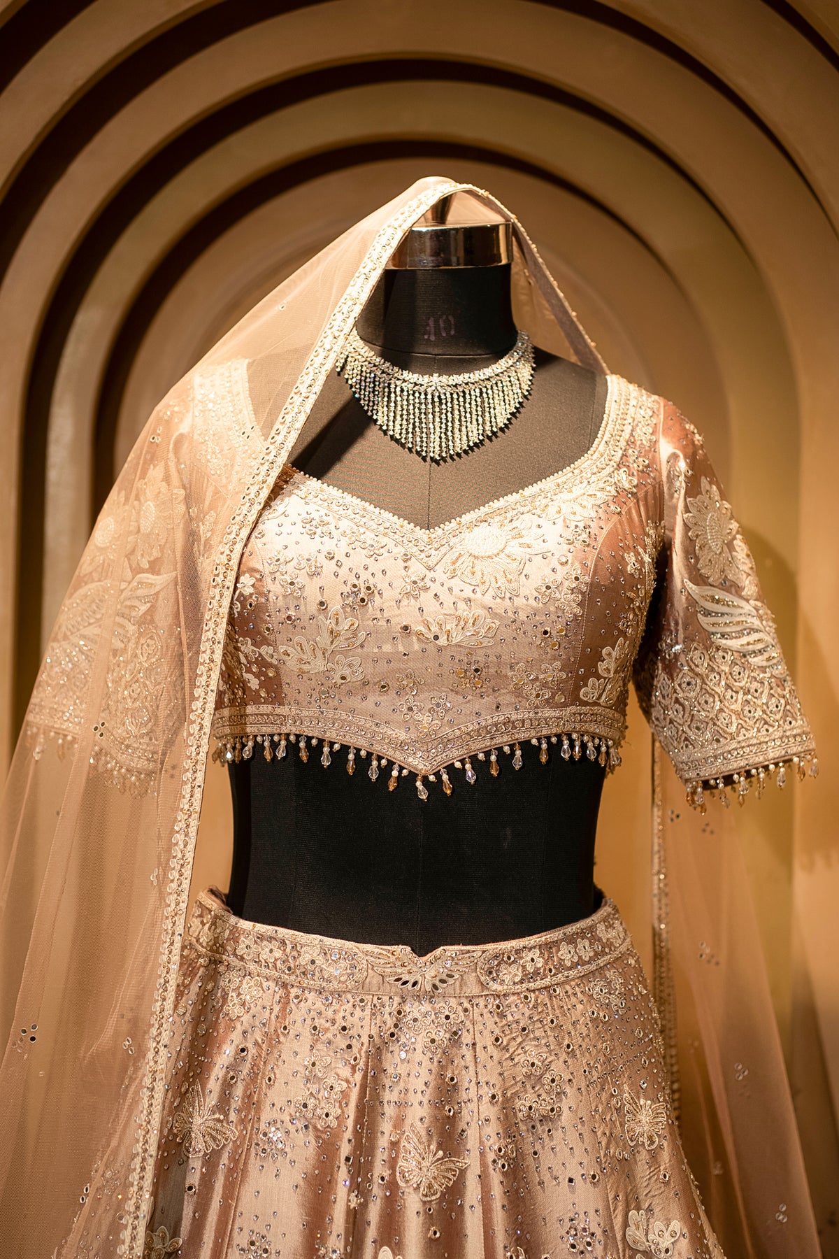 Intricate dori-mirror fusion details on the Champagne Brown Silk Lehenga