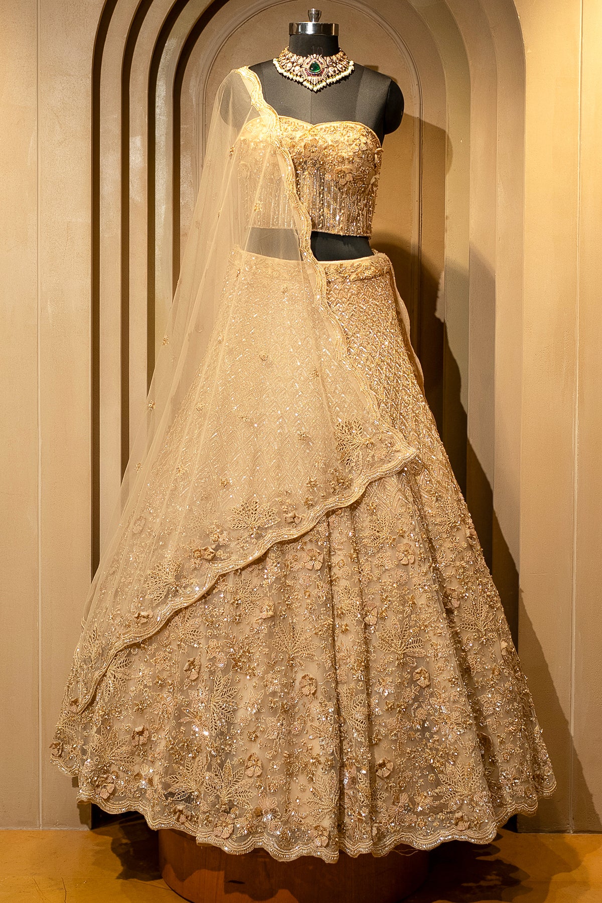 Architectural cutwork details on the Champagne Gold Net Corset Lehenga