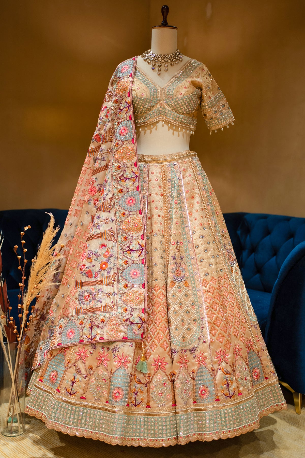 Close-up of multi-hue hand-embroidery on the Gilded Floral Tissue Silk Lehenga