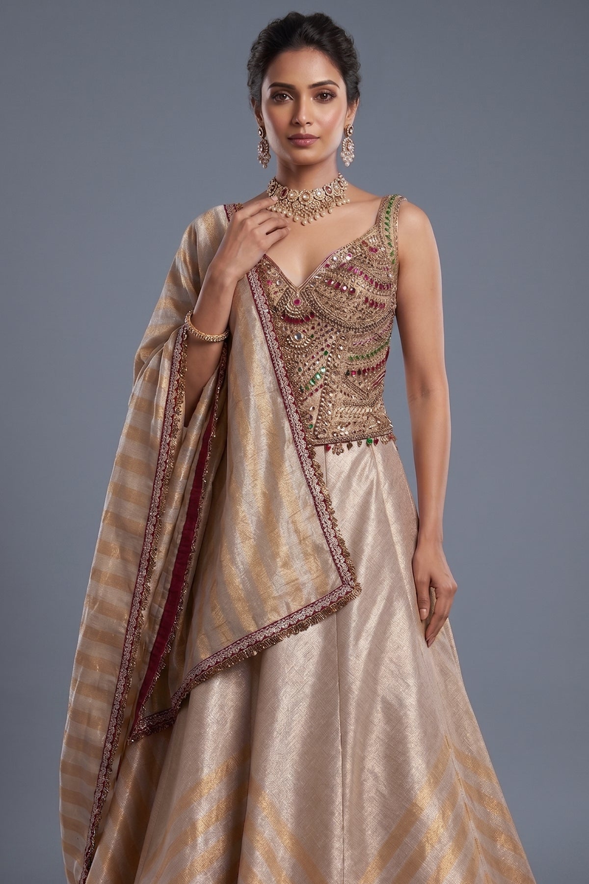 Golden Tissue Silk Lehenga close up of intricate hand-embroidery and gemstone detailing