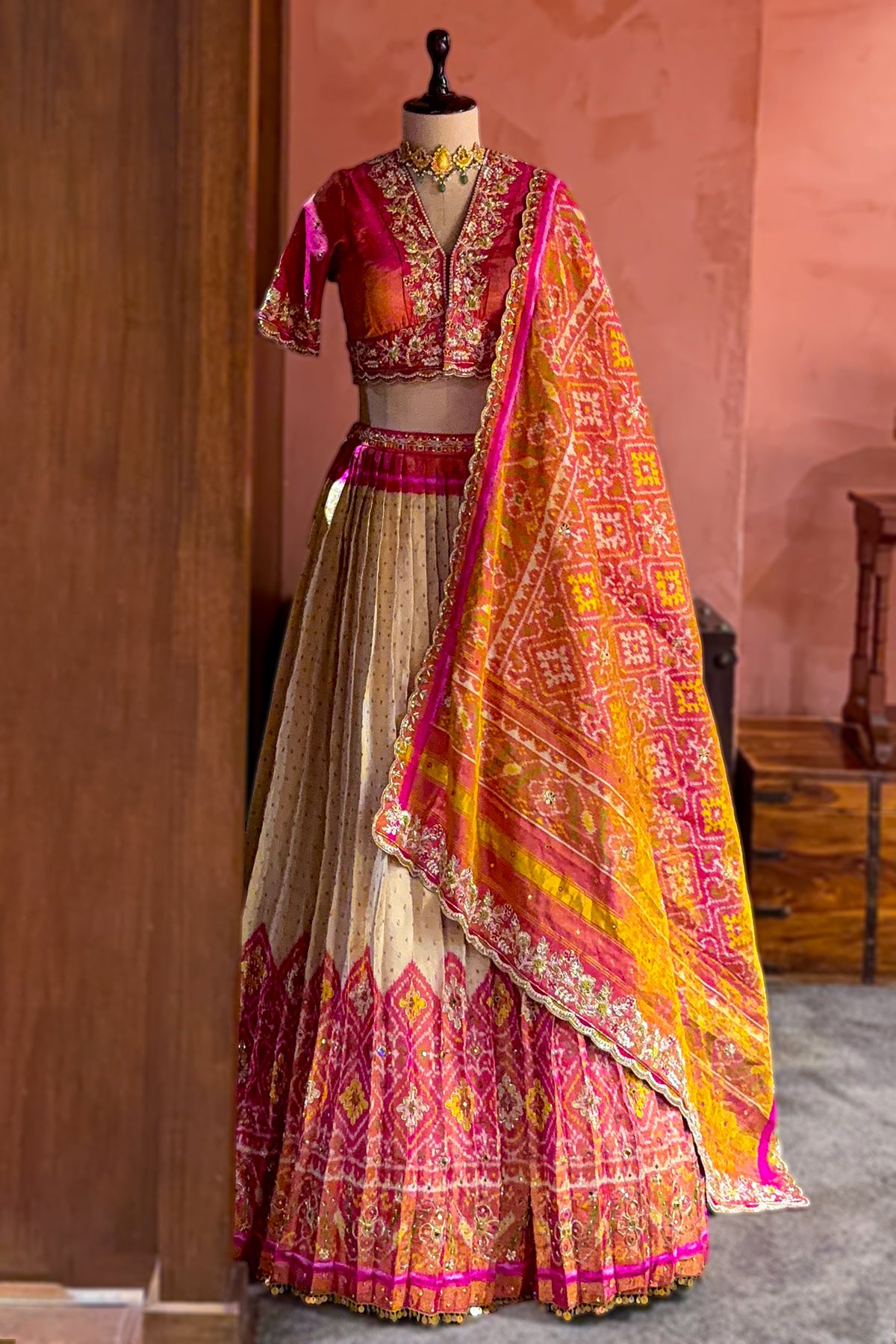 Cream and Fuchsia Two-Tone Tissue Silk Pleated Patola Ikkat Lehenga with Hand-Embellished Zardosi V-Neck Blouse