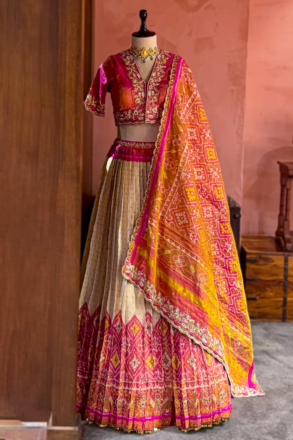 Cream and Fuchsia Two-Tone Tissue Silk Pleated Patola Ikkat Lehenga with Hand-Embellished Zardosi V-Neck Blouse