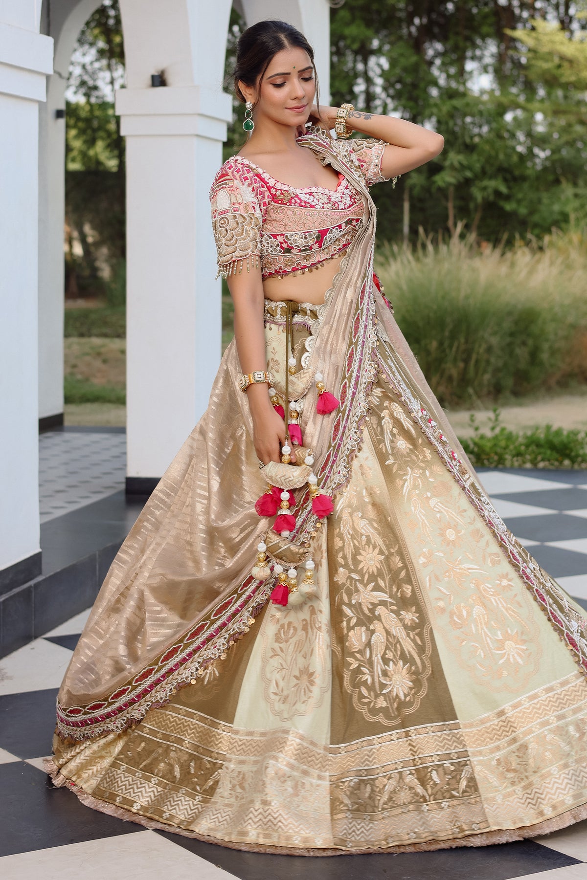 The Olive Green Shaded Brocade Silk Woven Lehenga Ensemble with Jharokha Embroidered Sweetheart Blouse and Attached Organza Dupatta