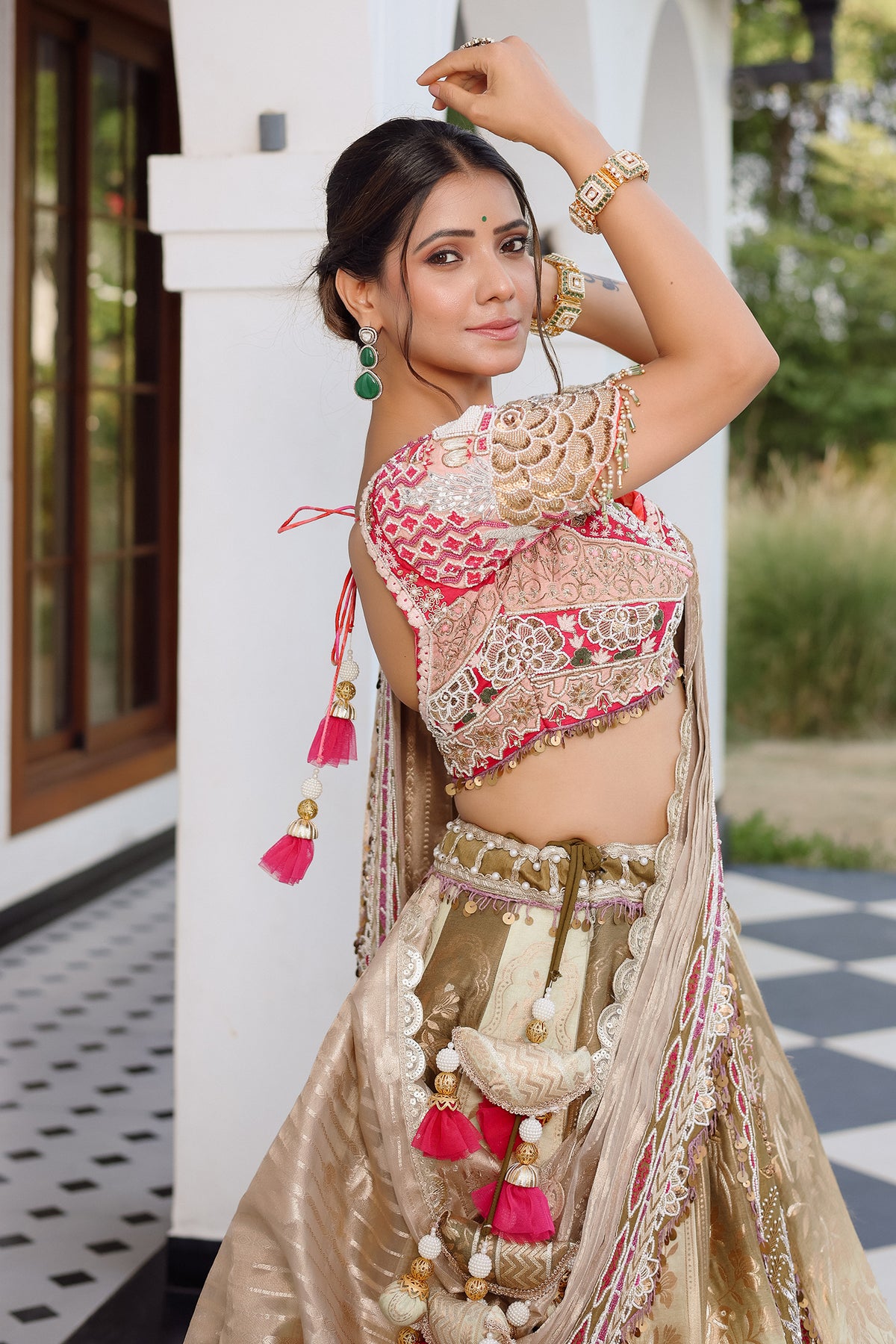 The Olive Green Shaded Brocade Silk Woven Lehenga Ensemble with Jharokha Embroidered Sweetheart Blouse and Attached Organza Dupatta