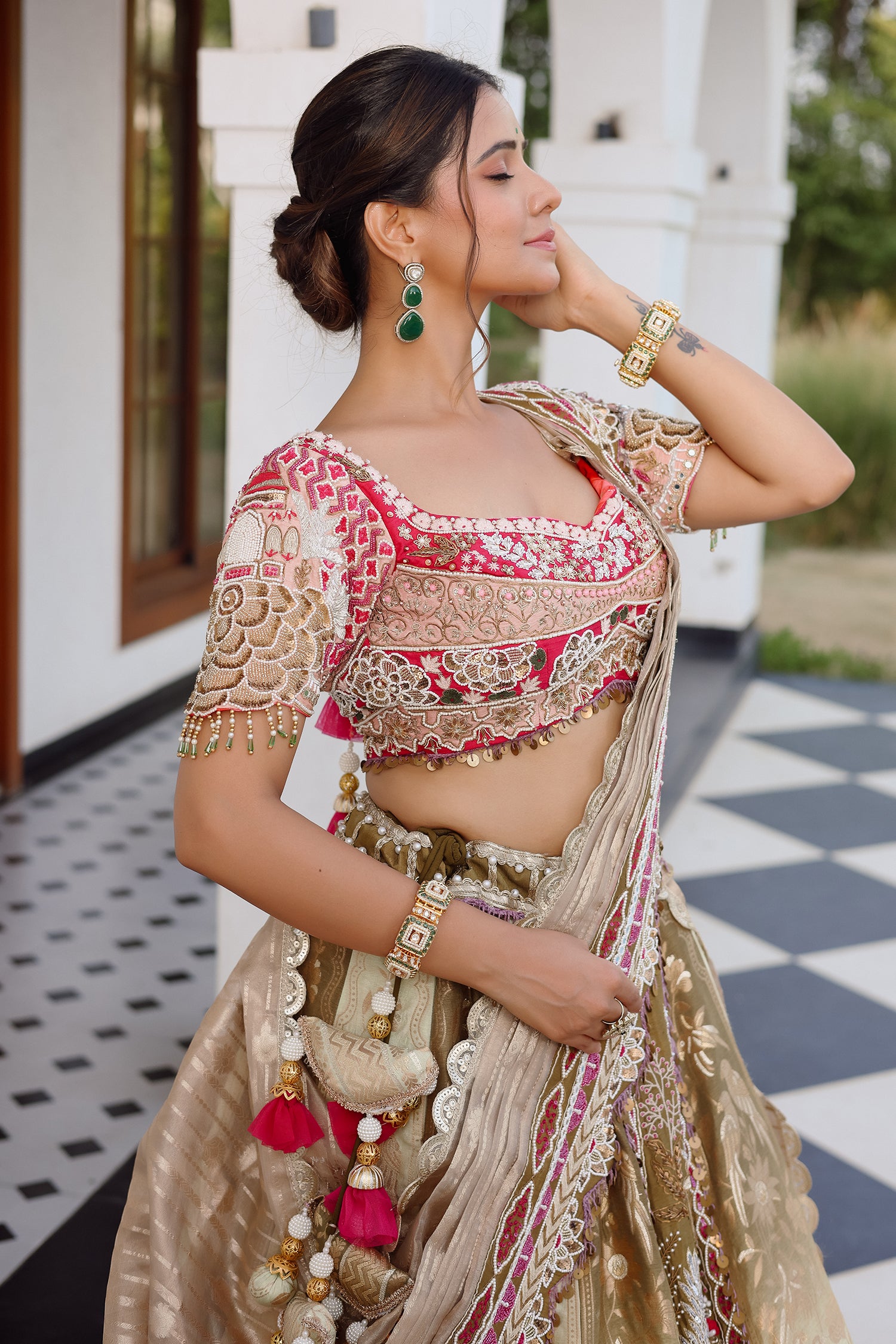 The Olive Green Shaded Brocade Silk Woven Lehenga Ensemble with Jharokha Embroidered Sweetheart Blouse and Attached Organza Dupatta