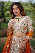 The Beige Gold Tissue Silk Kalidar Lehenga Ensemble with Hand-Embellished V-Shape Blouse and Scalloped Organza Dupatta