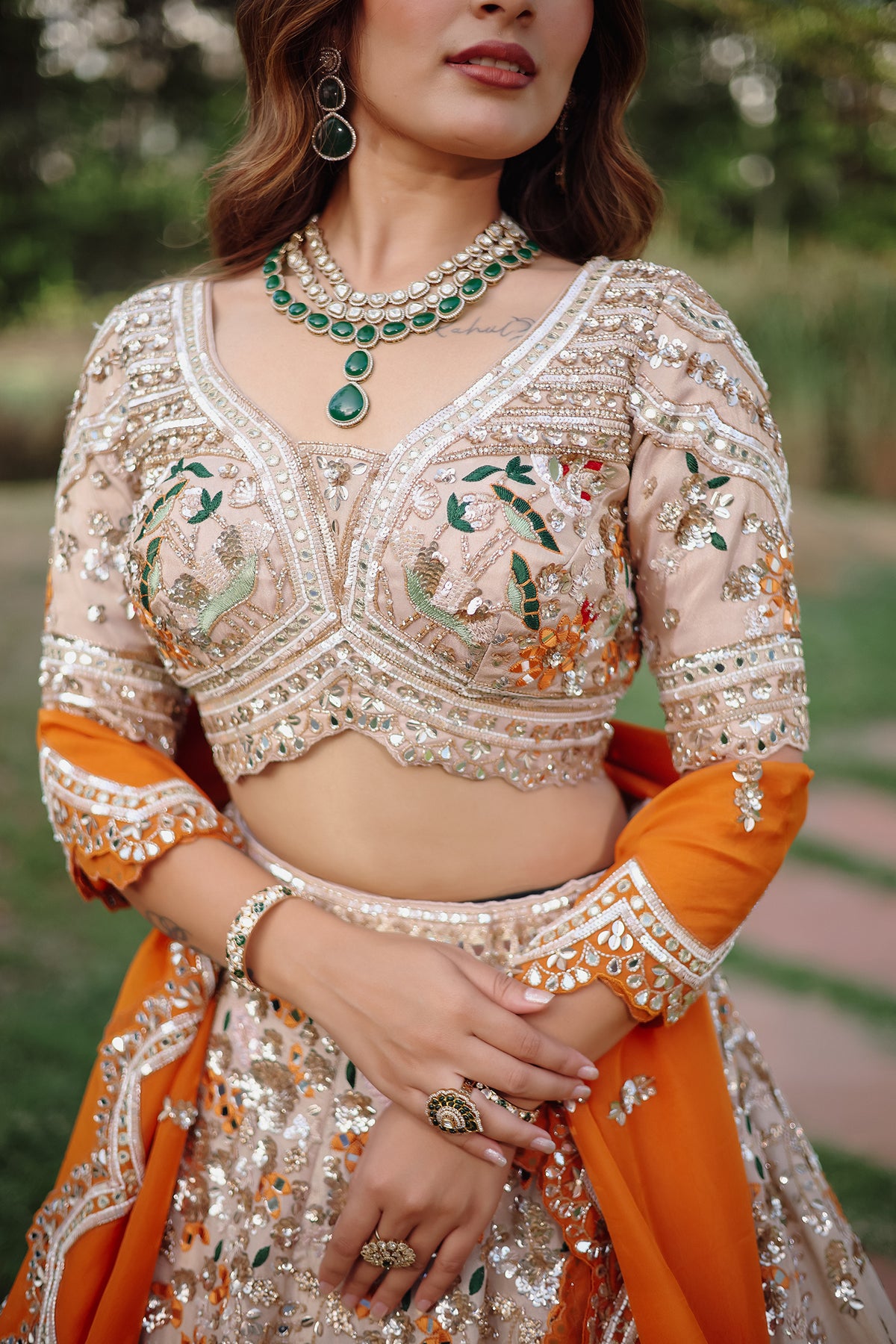 The Beige Gold Tissue Silk Kalidar Lehenga Ensemble with Hand-Embellished V-Shape Blouse and Scalloped Organza Dupatta