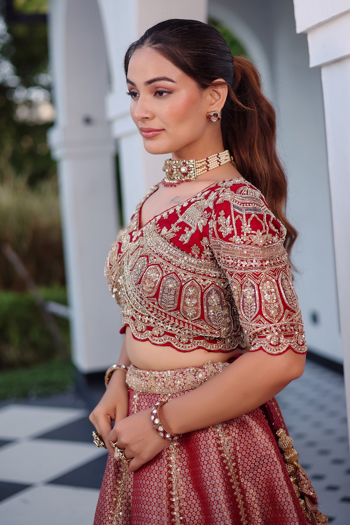 The Majestic Maroon Banarasi Silk Bridal Lehenga Ensemble with Jharokha Zardosi Blouse and Sheer Scalloped Veil