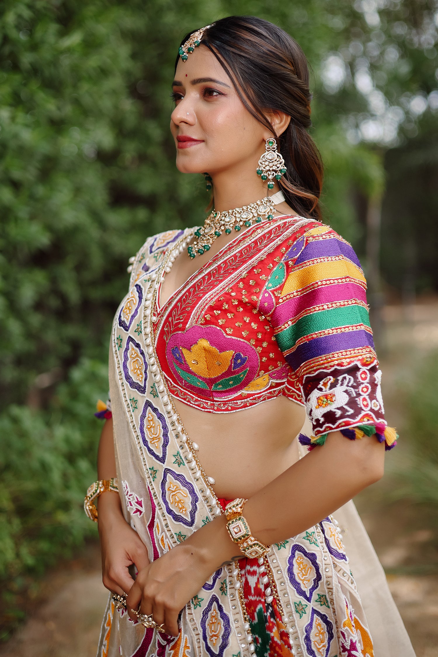 The Rajwadi Patola Silk Lehenga Ensemble With Scalloped V-Neck Hand-Embellished Blouse And Sheer Organza Tissue Dupatta