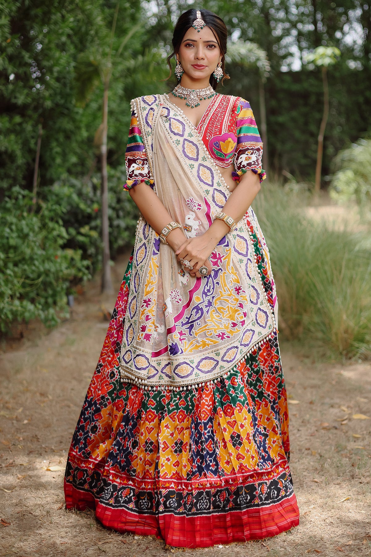 The Rajwadi Patola Silk Lehenga Ensemble With Scalloped V-Neck Hand-Embellished Blouse And Sheer Organza Tissue Dupatta