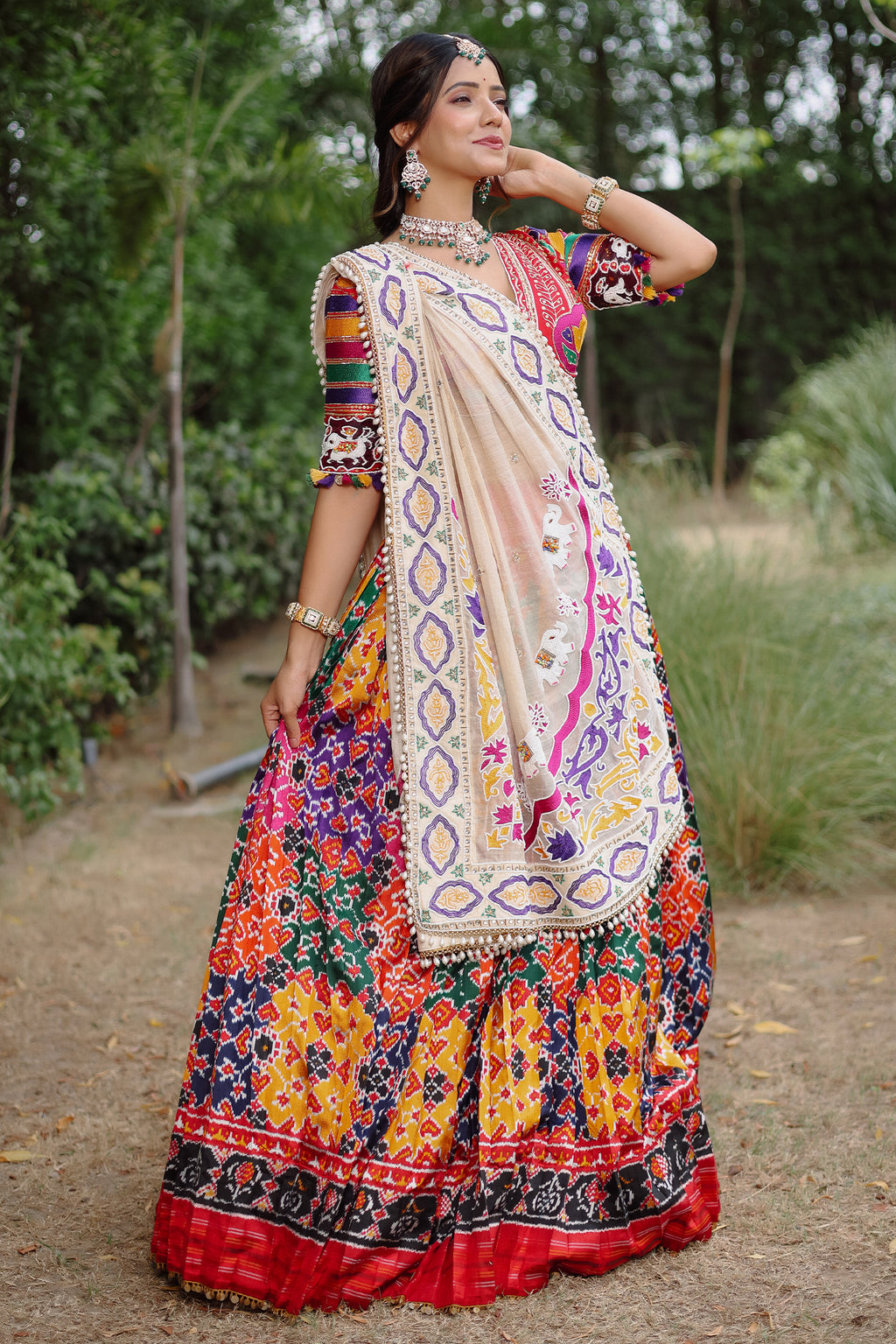 The Rajwadi Patola Silk Lehenga Ensemble With Scalloped V-Neck Hand-Embellished Blouse And Sheer Organza Tissue Dupatta