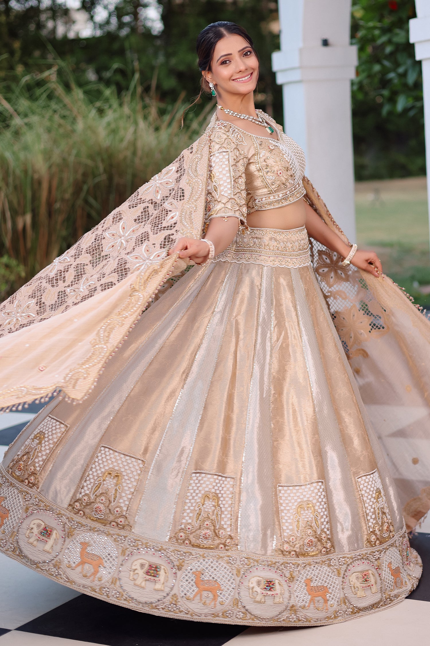 The Imperial Gold Jacquard Brocade Woven Silk Kalidar Lehenga Ensemble with Handcrafted Jewel Blouse and All-Over Cutwork Tissue Dupatta