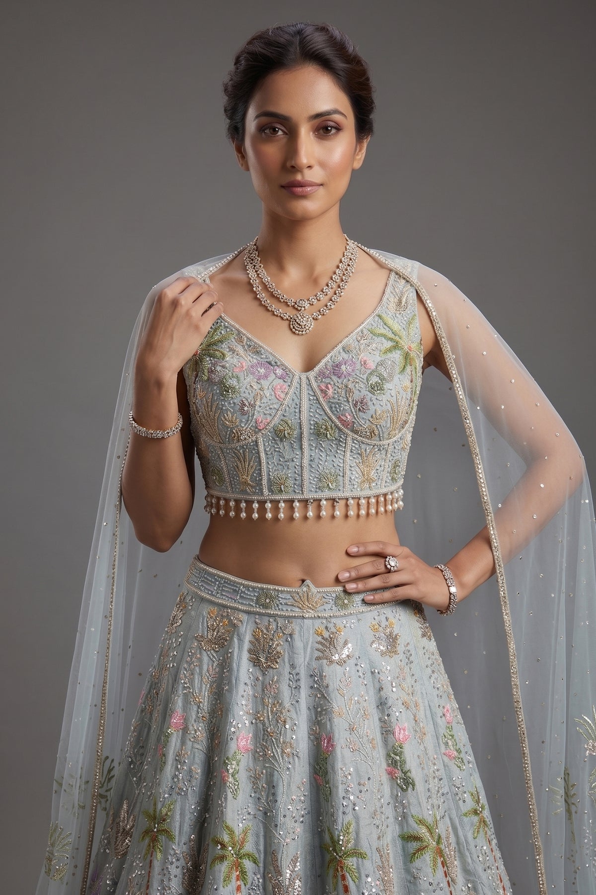 Powder Blue Tissue Flared Lehenga Skirt with Cutdana Embroidered Net Bustier and Sequin Cape Sleeves