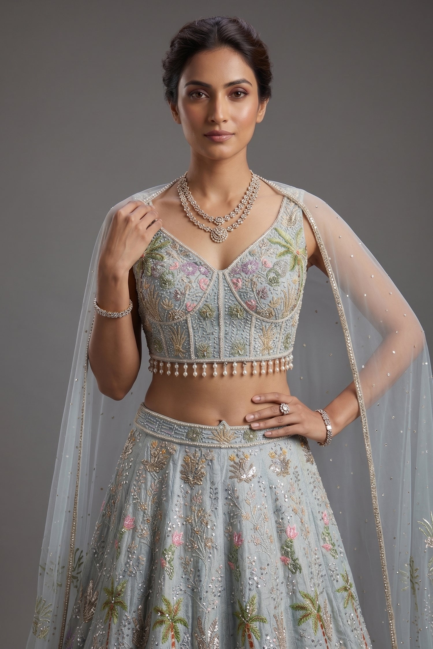 Powder Blue Tissue Flared Lehenga Skirt with Cutdana Embroidered Net Bustier and Sequin Cape Sleeves