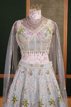 Powder Blue Tissue Flared Lehenga Skirt with Cutdana Embroidered Net Bustier and Sequin Cape Sleeves