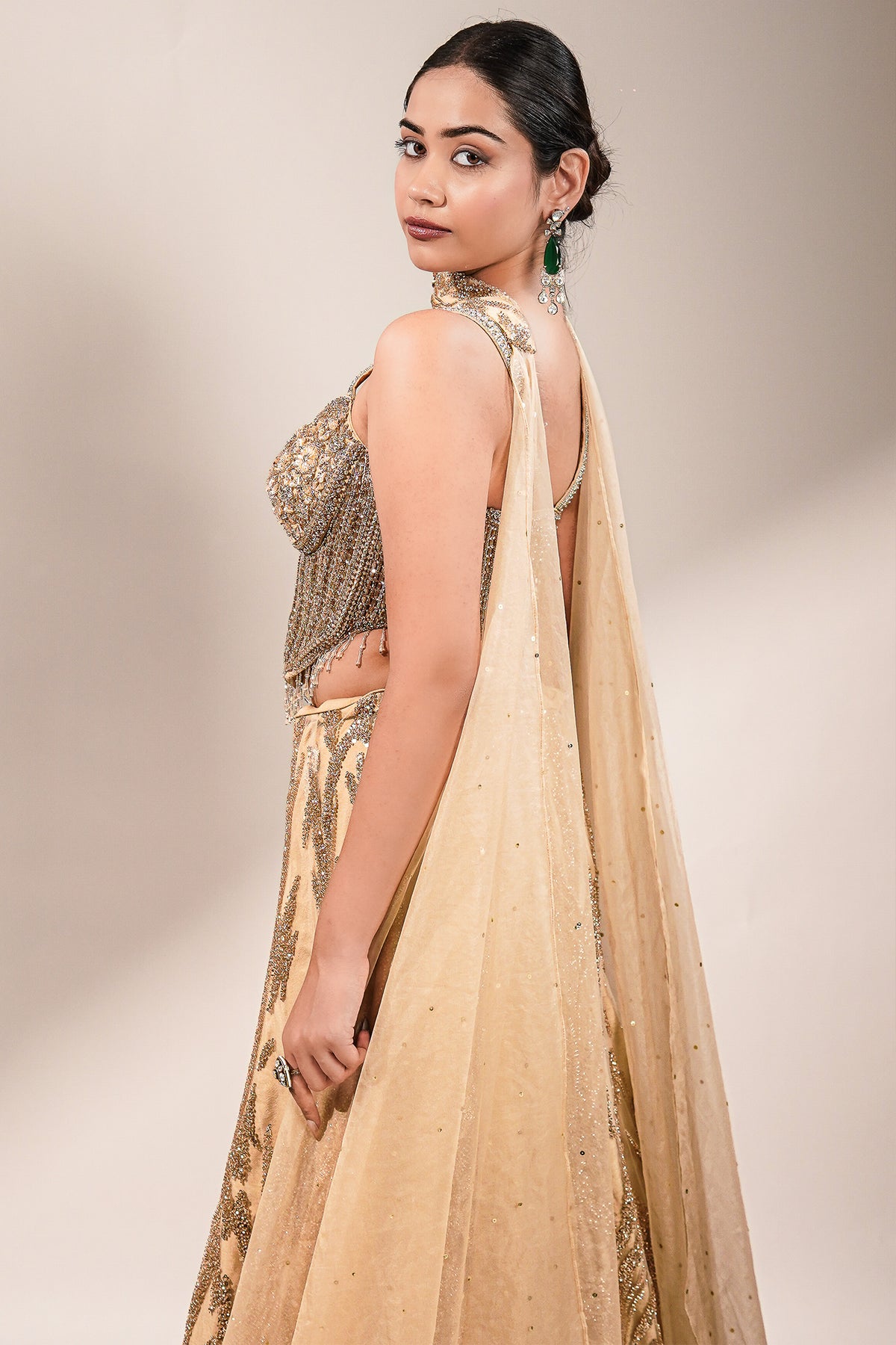 Champagne Beige Net Lehenga featuring Linear Sequin Trails and Beaded Tassel Bustier