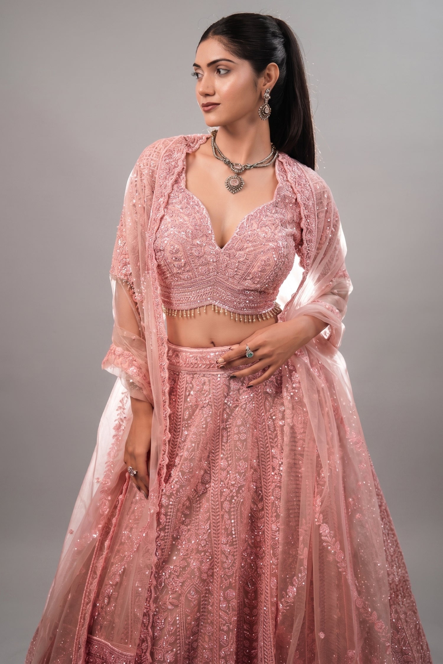 Blossom Pink Net Lehenga featuring Hand-Embellished V-Neck Blouse with Hanging Beads