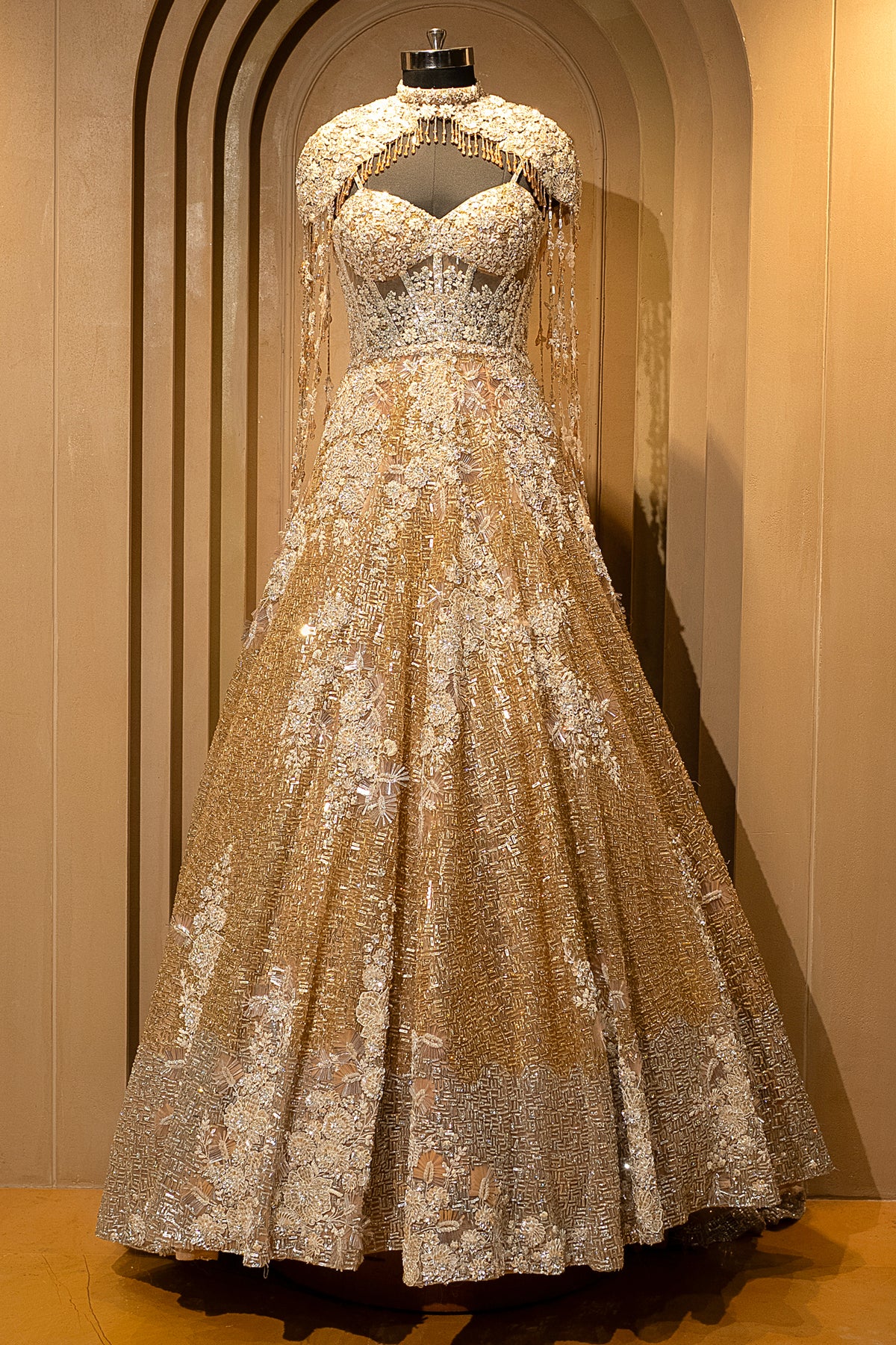 Ethereal detachable shoulder capes on the Champagne Gold Net Couture Gown