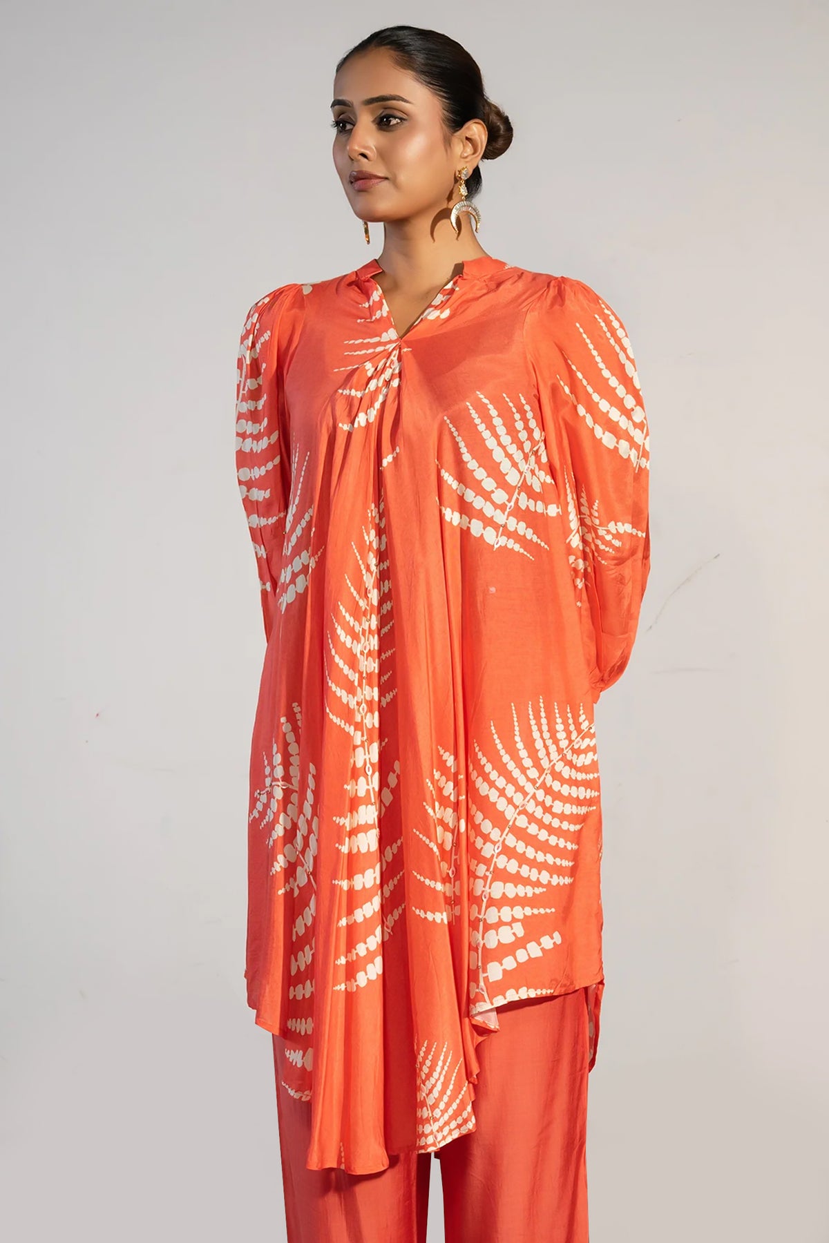 Close-up of the vibrant digital print on the Orange Crepe Printed Kurti with Pant