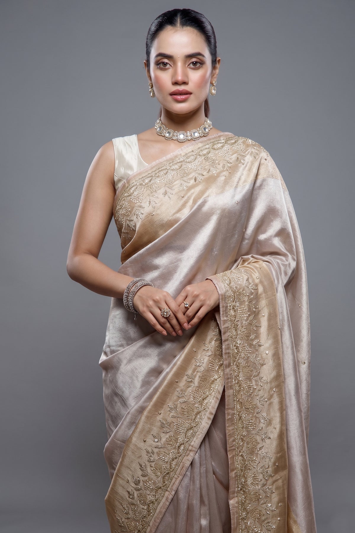 Close-up of intricate Cutdana and delicate beadwork on the Silver and Golden Tissue Silk Saree