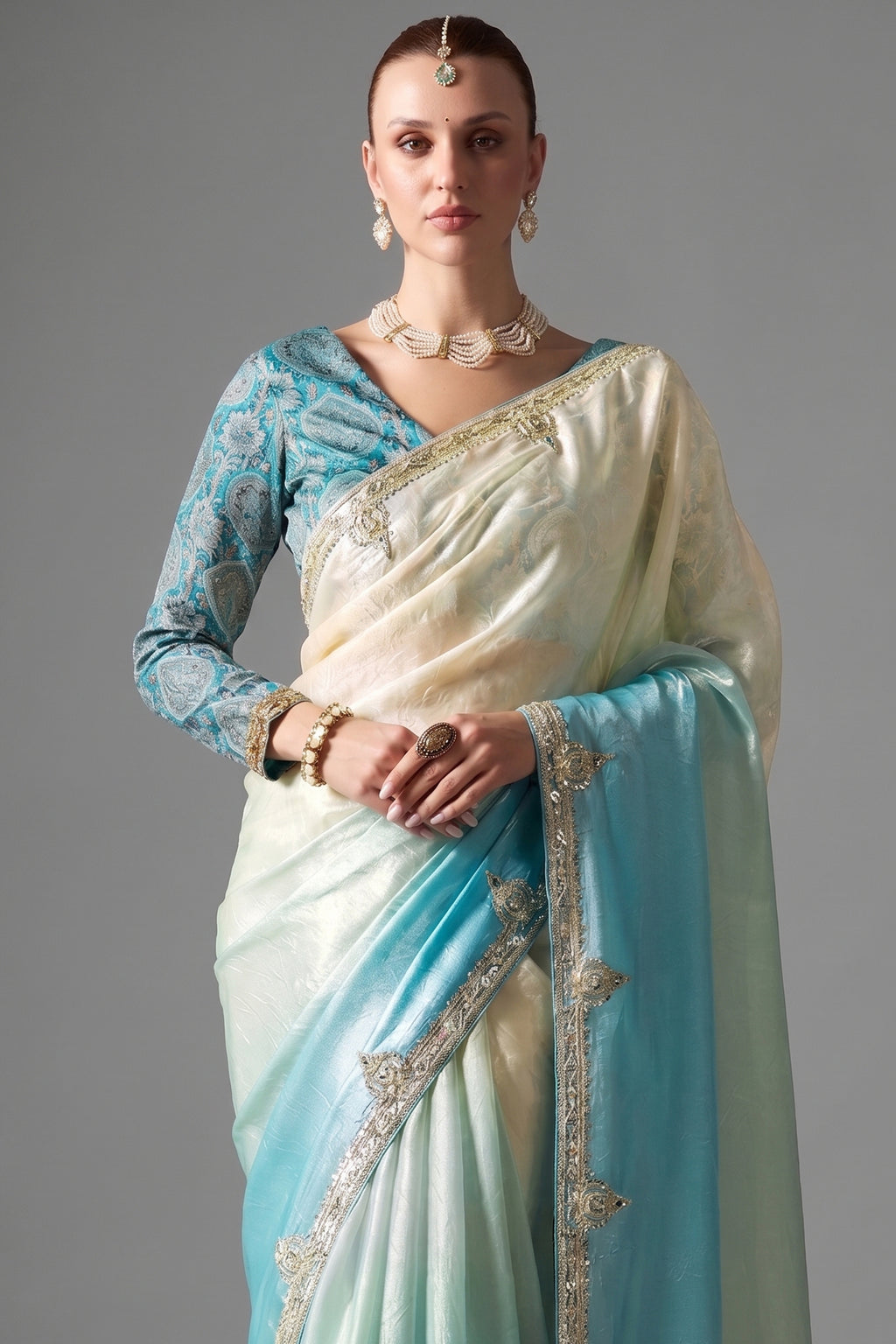 Ombre Sky Blue Tissue Saree Embellished With Sequins And Paired With A Matching Azure Print Blouse.