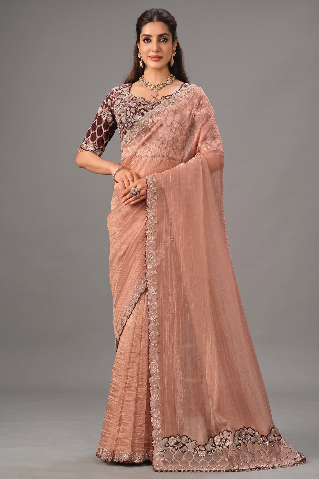 Peach Crush Tissue Saree highlighted with Shimmering Sequins and Pearls