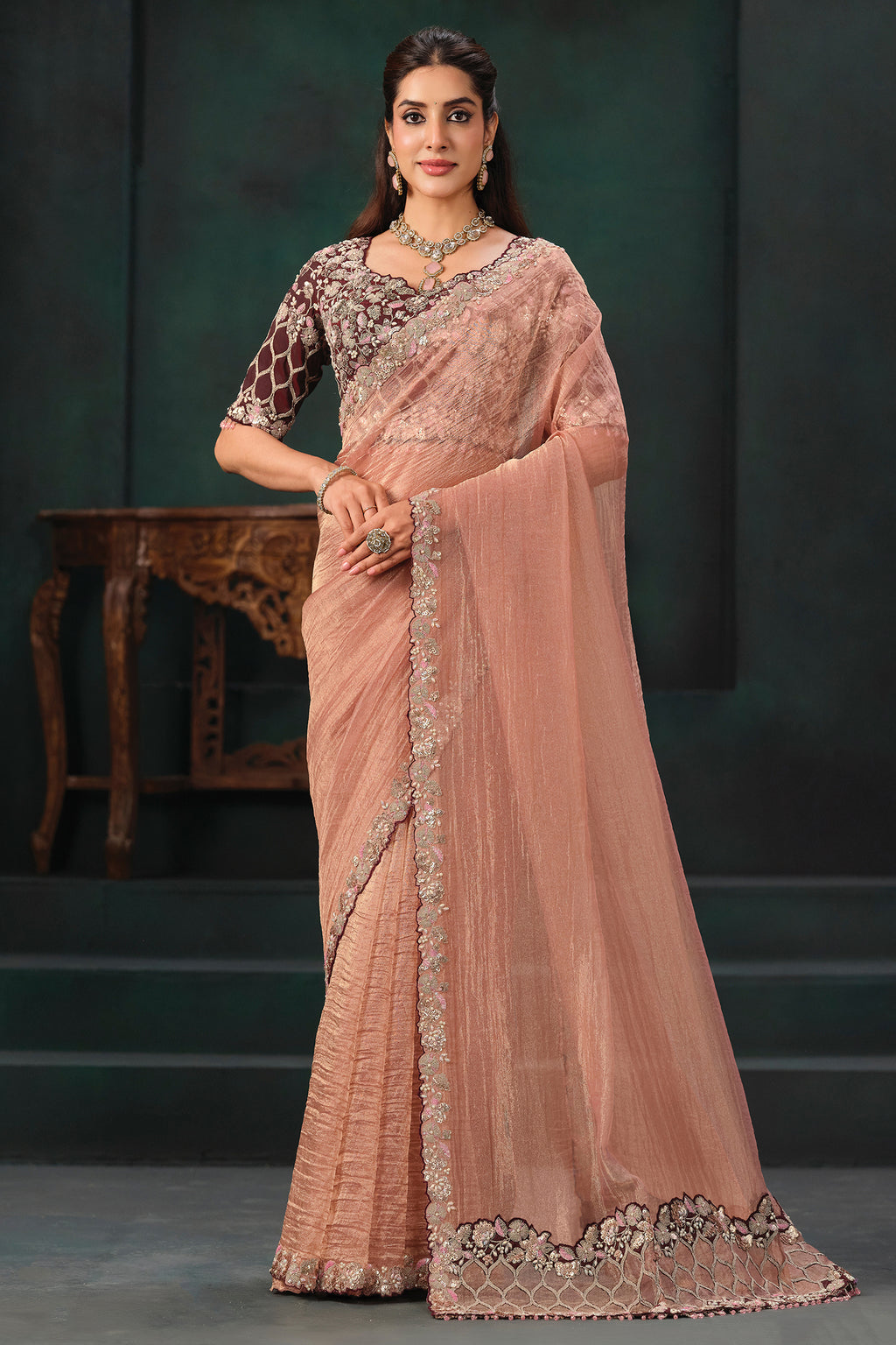 Peach Crush Tissue Saree highlighted with Shimmering Sequins and Pearls