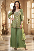 Model wearing Pista Green Chinon Silk Woven and Mirror Worked Palazzo Suit with Front Slit Peplum Kurta