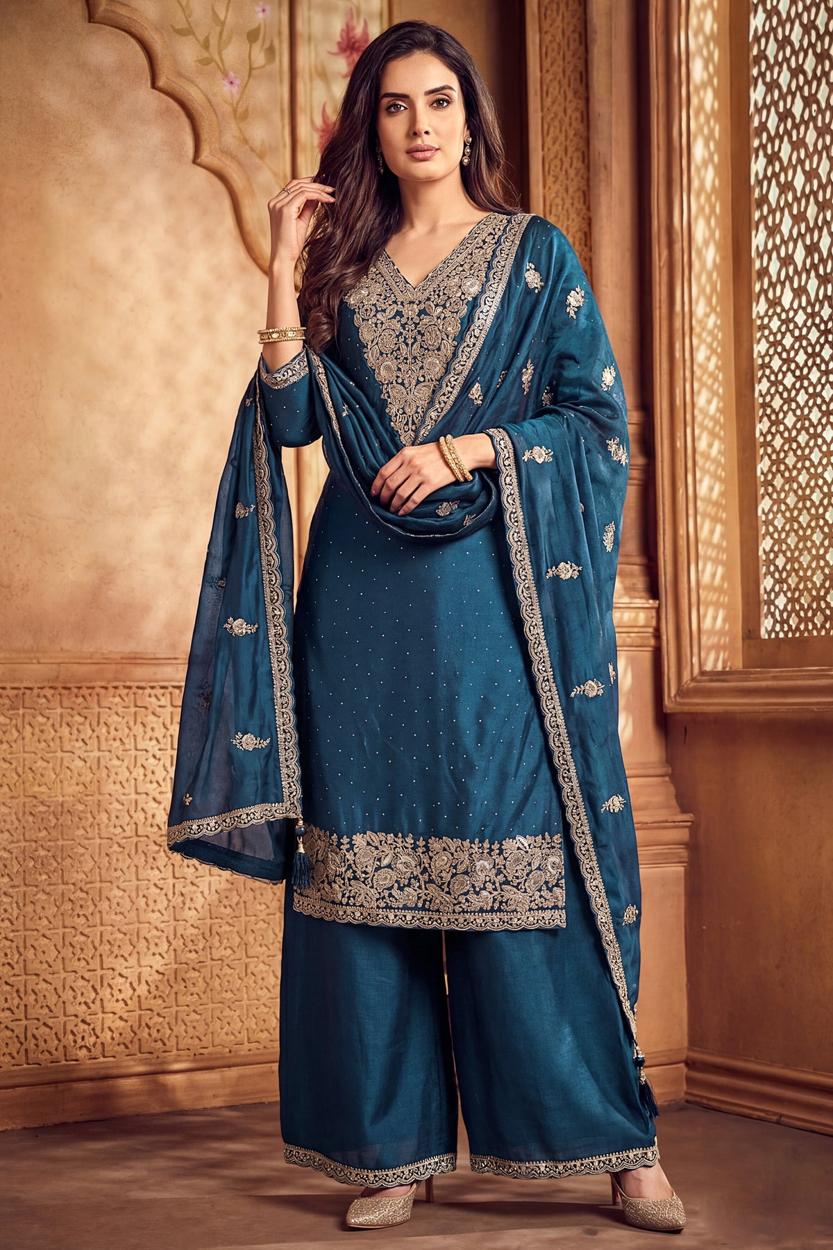 Model wearing traditional rama blue art silk embroidered palazzo suit