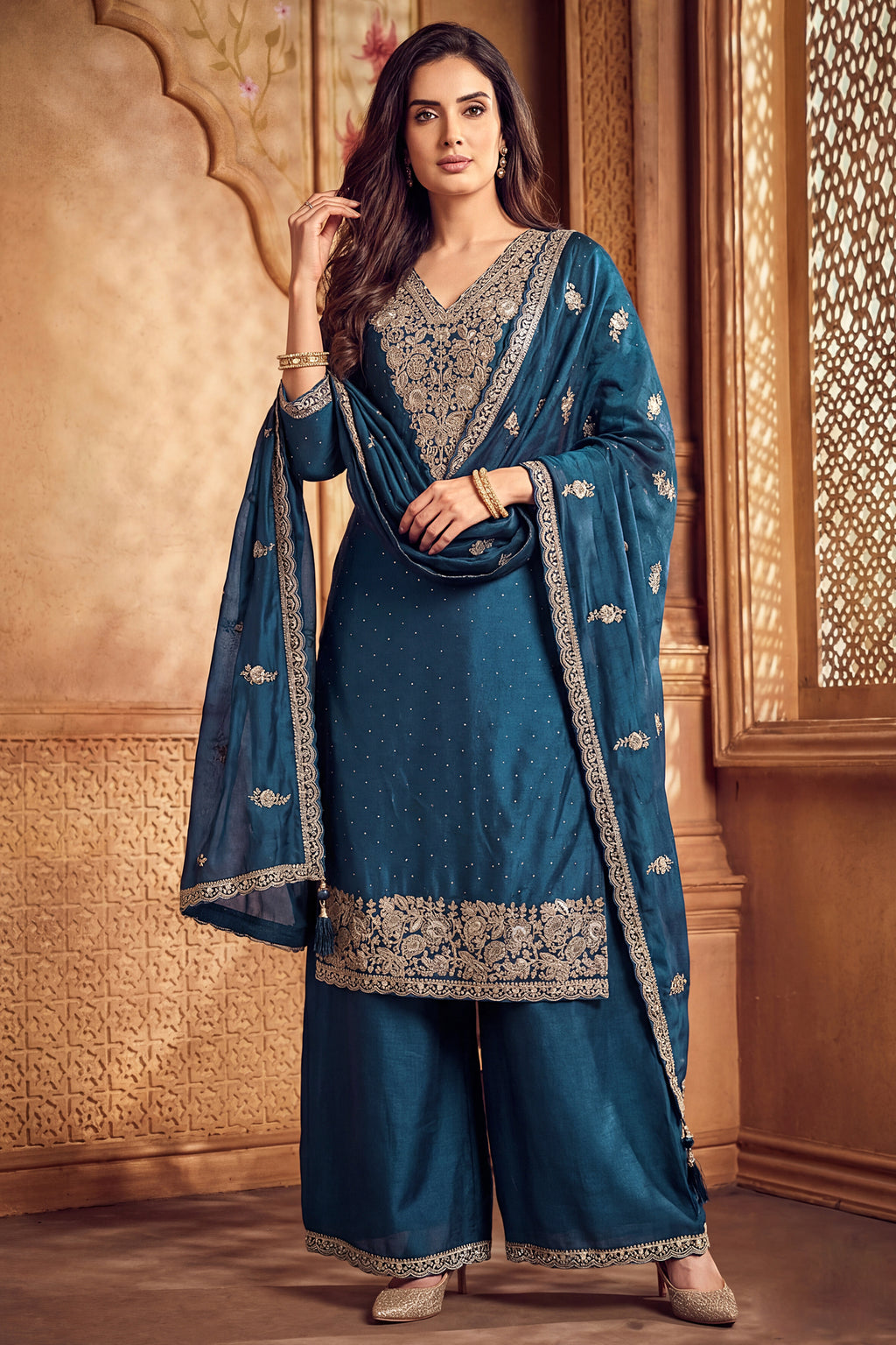 Model wearing traditional rama blue art silk embroidered palazzo suit