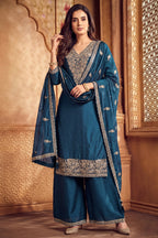 Model wearing traditional rama blue art silk embroidered palazzo suit