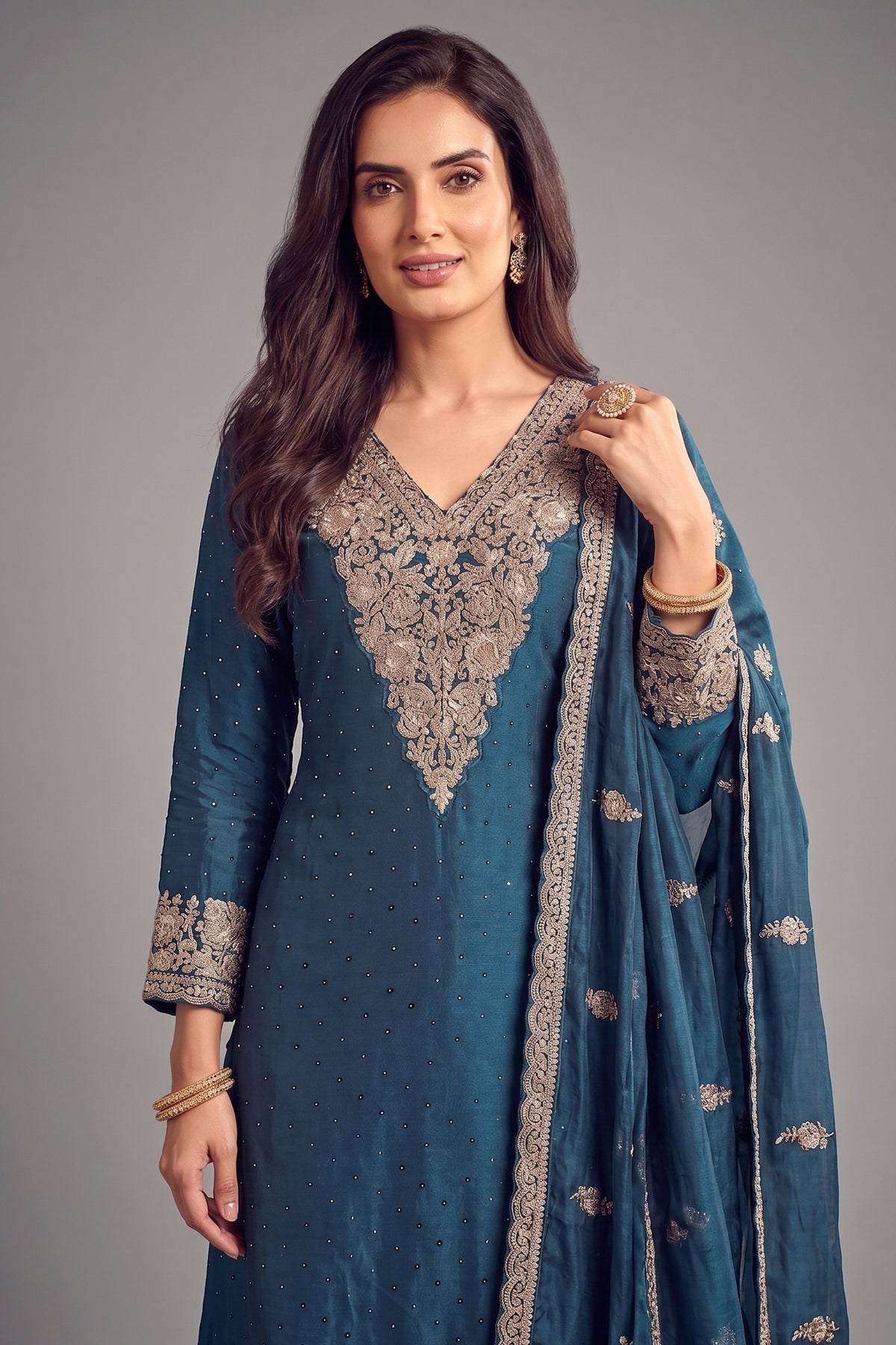 Close up of detailed floral thread embroidery on rama blue palazzo suit