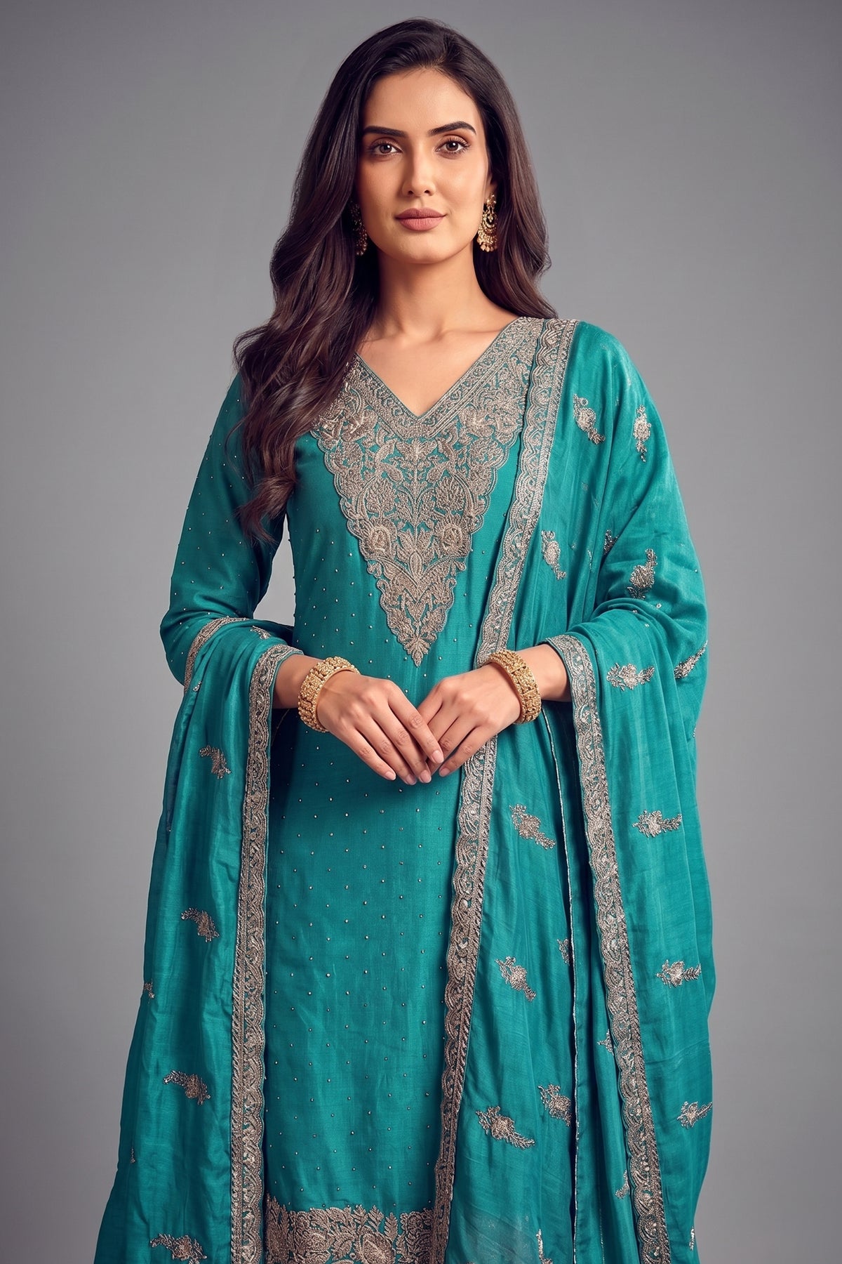 Close up of detailed floral embroidery on turquoise blue art silk suit kurta