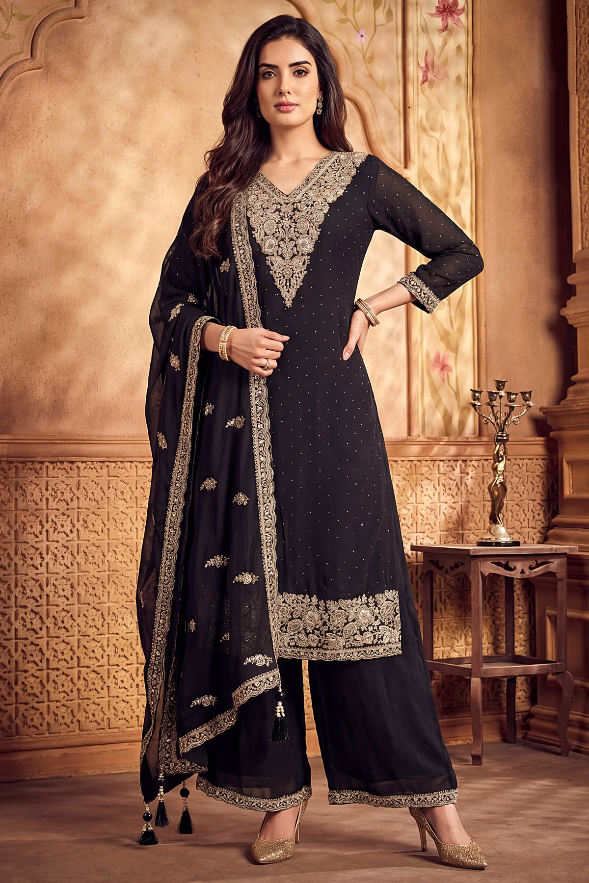 Model wearing black art silk straight cut kurta with wide leg palazzos
