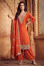 Model wearing orange art silk palazzo suit with scalloped embroidery dupatta