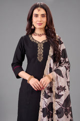 Close up of detailed neckline embroidery on black art silk suit
